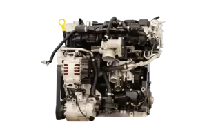 Mechanic inspecting a used Mitsubishi engine, featuring the 4G63 engine for sale